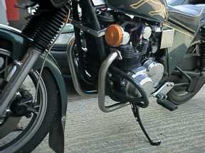 [Front view of bike with partial exhaust ]