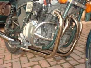 [front of bike feturing exhaust and engine bars ]